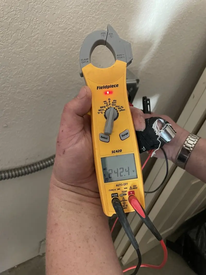 Voltage testing with clamp meter during Recessed Lighting Installation in Baraga